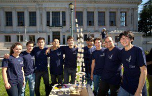 a group of students in Berkeley Engineering shirts smiling outside Doe Library