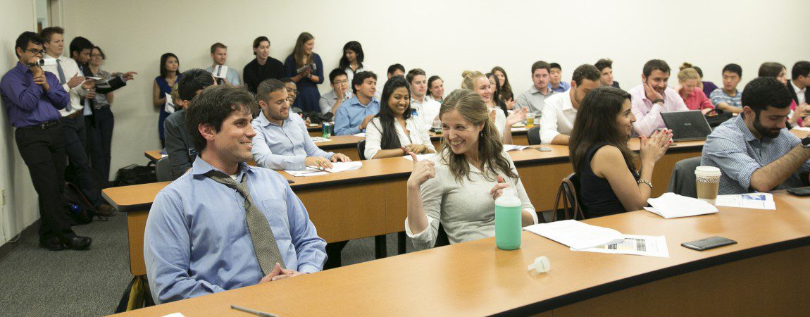 students sitting in a classroom and smiling