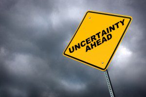 a yellow traffic sign reading "Uncertainty Ahead"