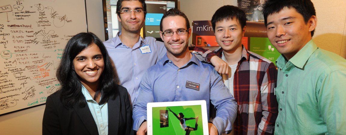 five students posing with a tablet reading "mKinect"
