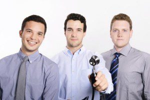 three men holding a stethoscope