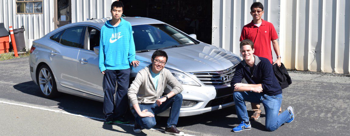 students posing with a Hyundai