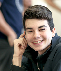 a student, Miguel, smiling at the camera