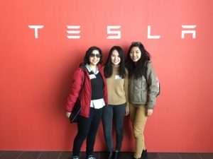 MEng students posing with Tesla sign