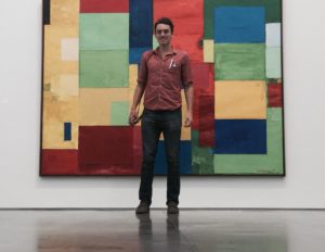 Jonathan McKinley standing in front of a painting
