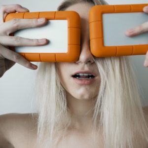 woman holding two white-and-orange plastic cases