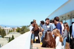 Alumni chatting at the 2019 Alumni Brunch overlooking the Bay