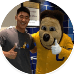 Michael Sun with his arms around Oski, the bear mascot of UC Berkeley.