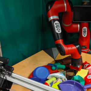 A red robot arm in a box of colorful toys.