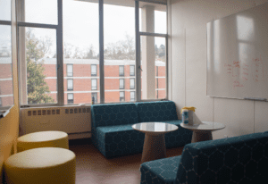 The interior of the student lounge at Shires Hall. It contains couches and whiteboards.