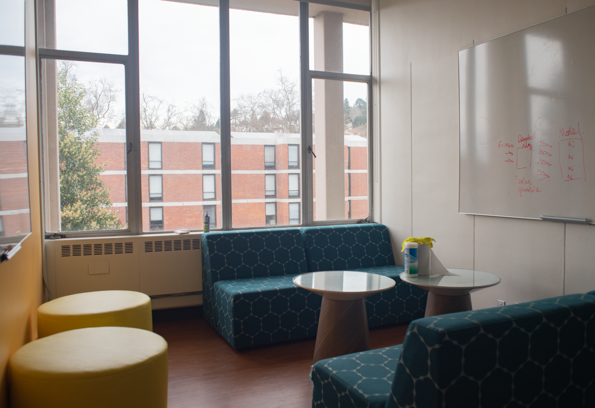 The interior of the student lounge at Shires Hall. It contains couches and whiteboards.